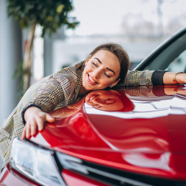 Beautiful woman hugging a car